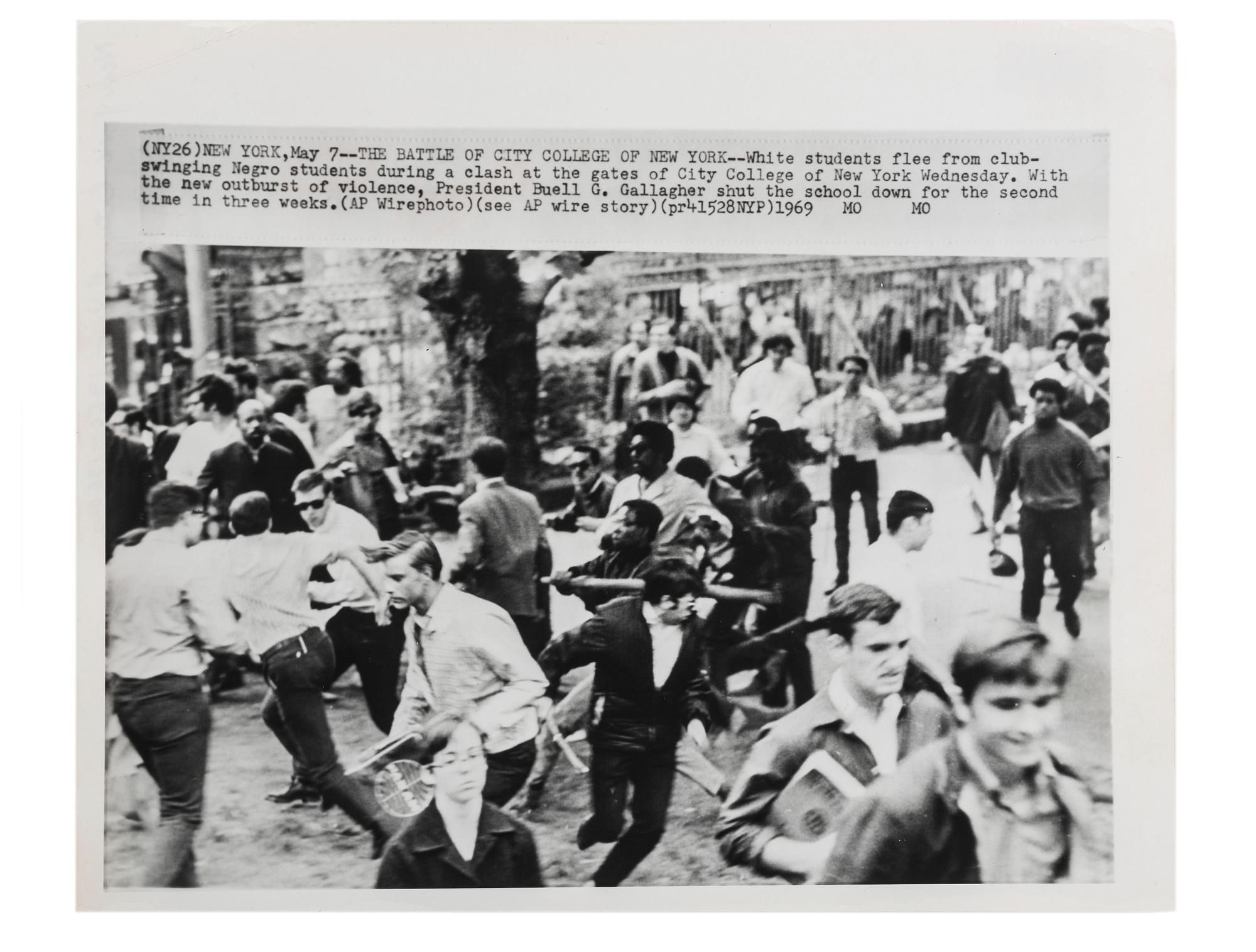 [CIVIL RIGHTS]. Press photograph capturing a clash between African American and white students at the gates of City College of New York. May 1969.
