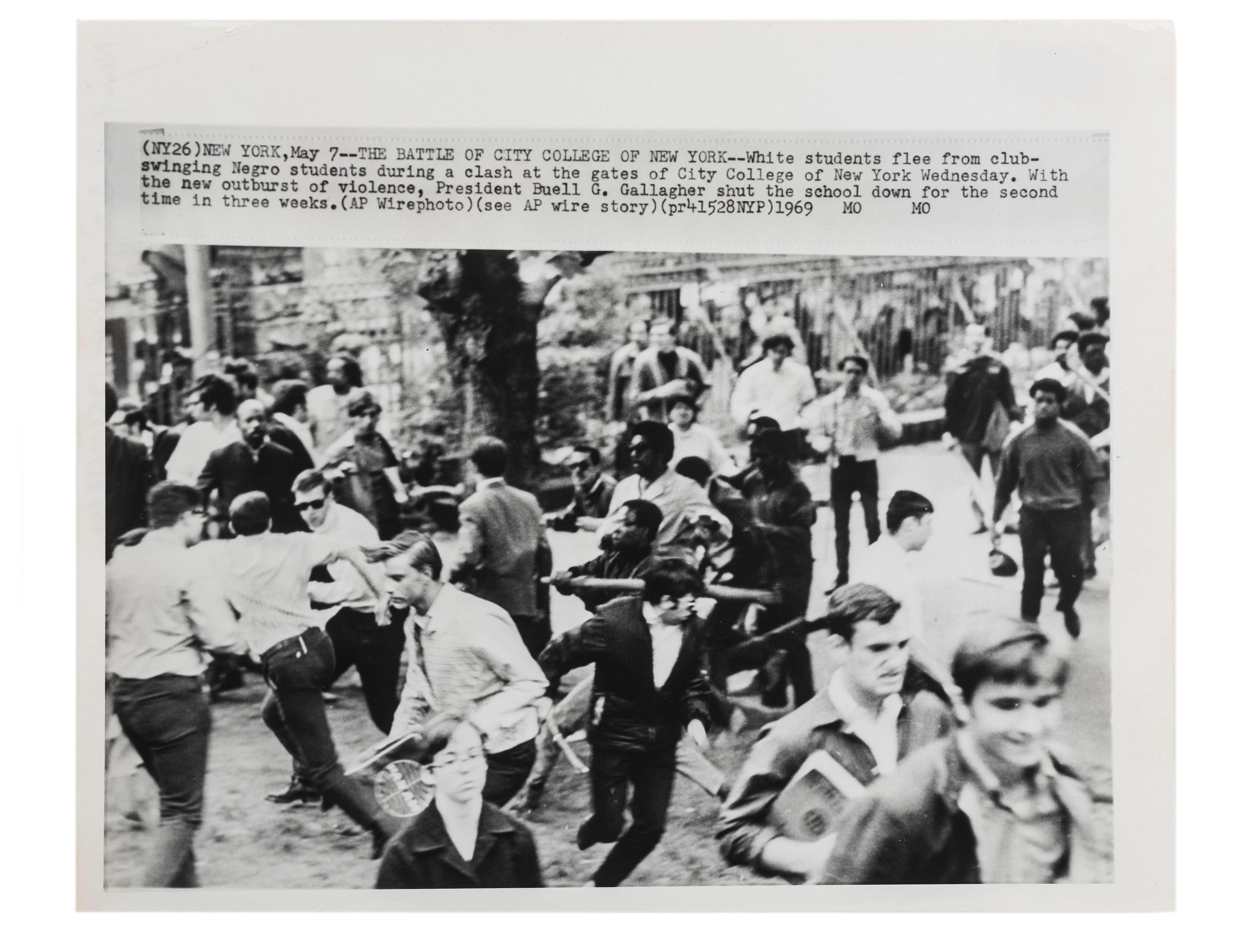 [CIVIL RIGHTS]. Press photograph capturing a clash between African American and white students at the gates of City College of New York. May 1969.