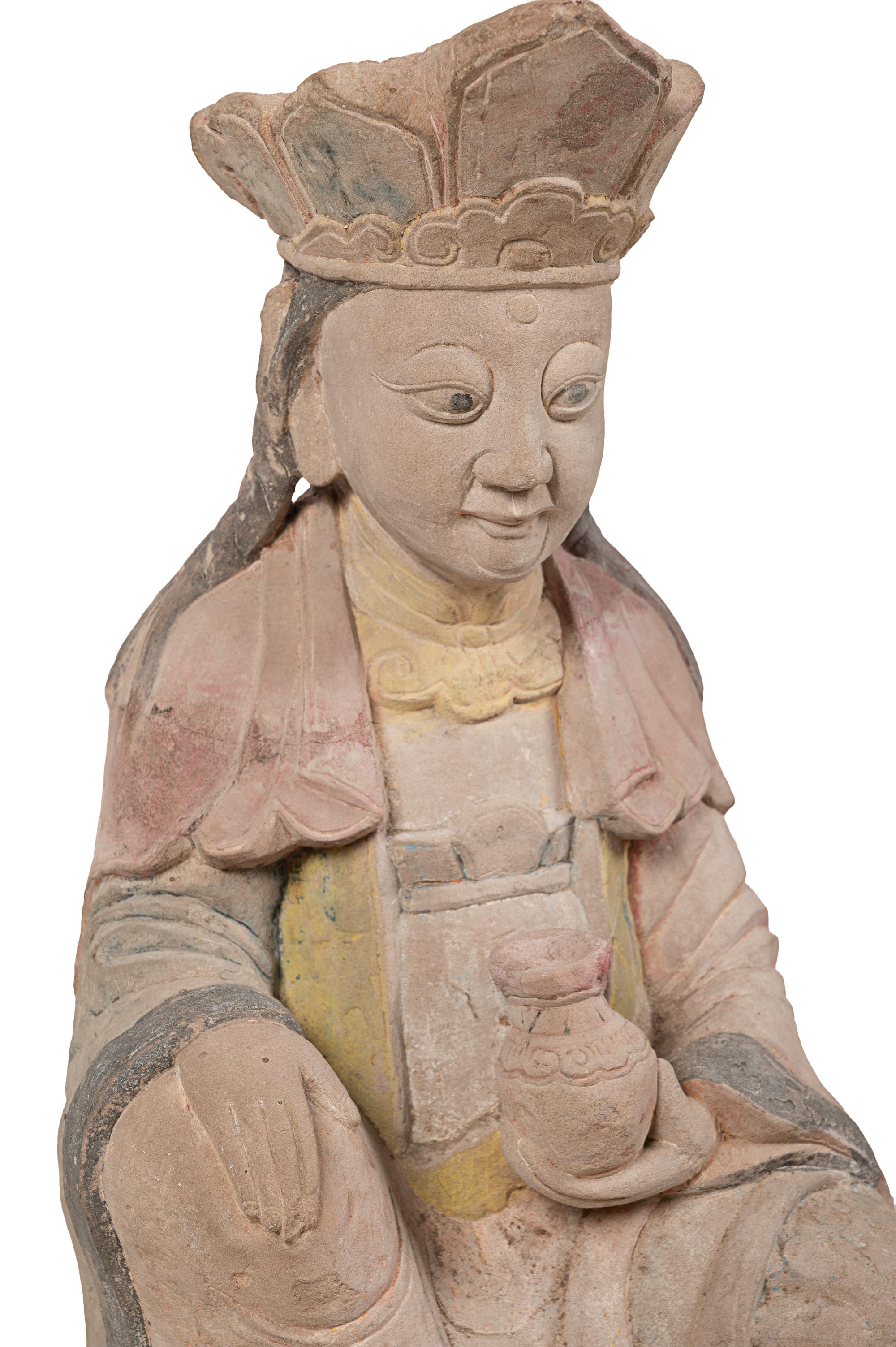 A Chinese Carved Stone Seated Figure with Polychrome Decoration