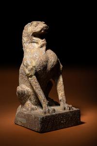 A Carved Puddingstone Figure of a Seated Lion