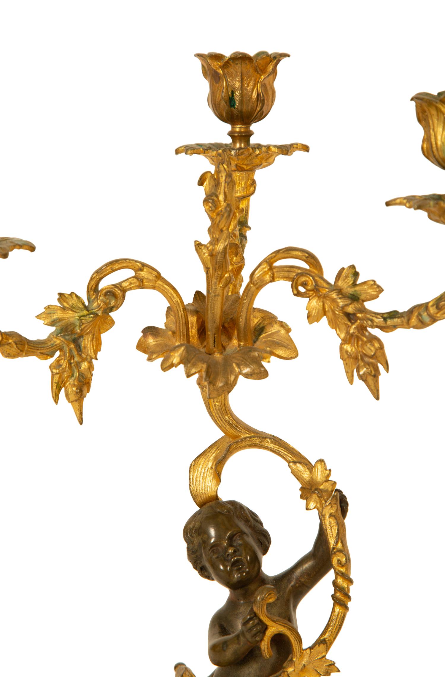 A Pair of Gilt and Patinated Bronze Figural Three-Light Candelabra