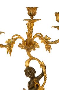 A Pair of Gilt and Patinated Bronze Figural Three-Light Candelabra