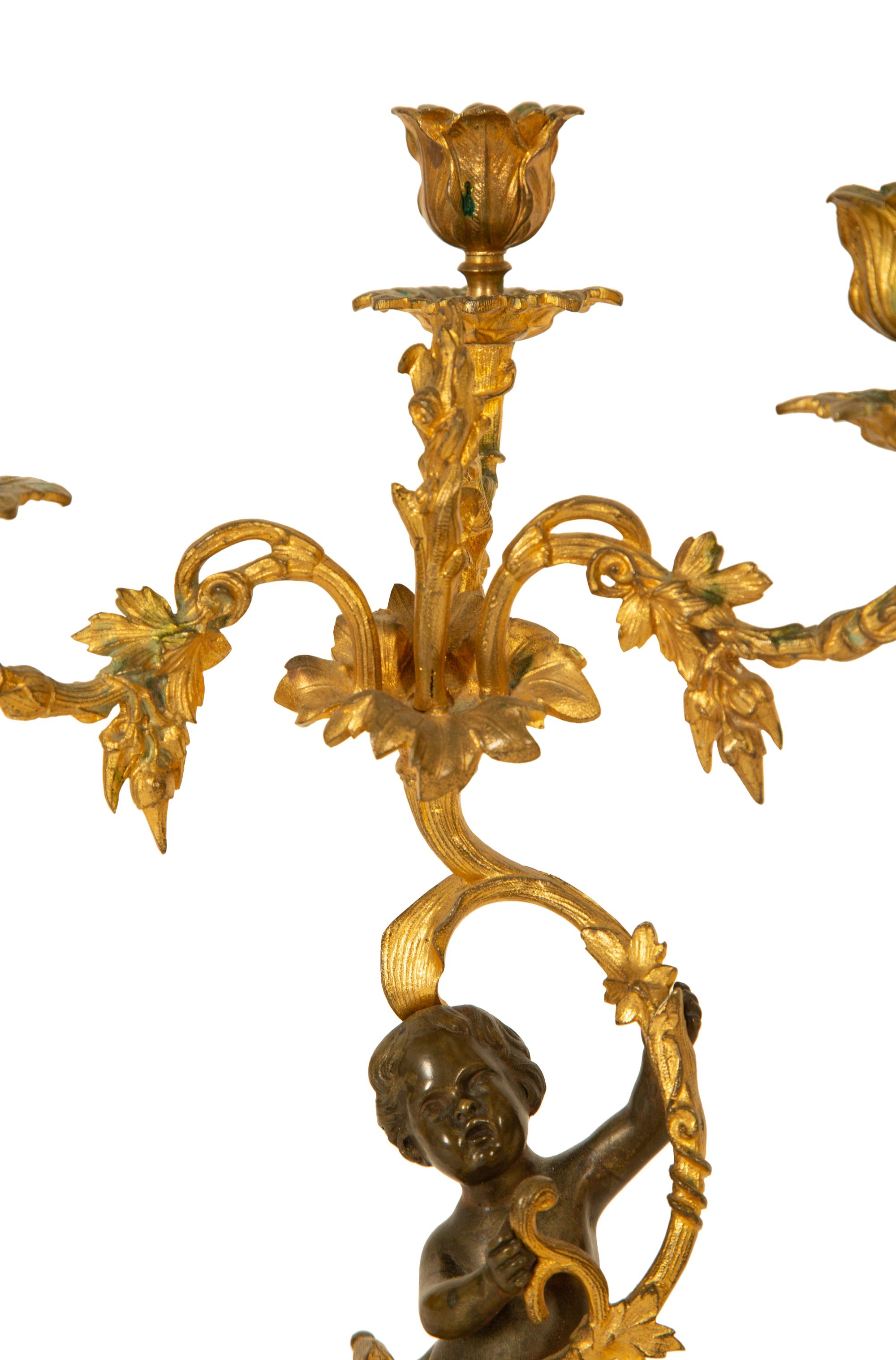 A Pair of Gilt and Patinated Bronze Figural Three-Light Candelabra