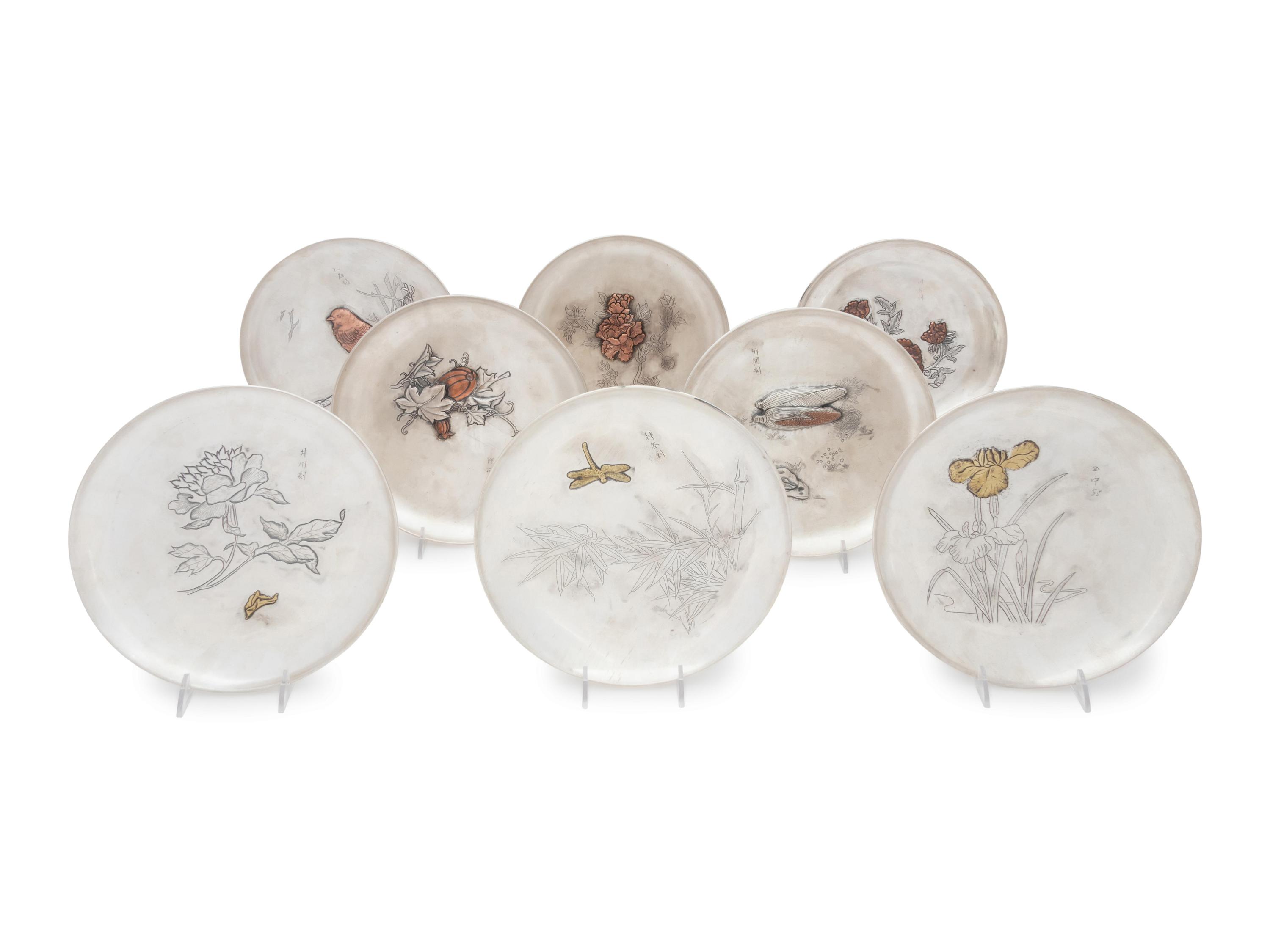 A Set of Eight Japanese Silver and Mixed Metal Plates