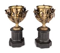 A Pair of Continental Gilt Bronze Urns on Slate Plinths