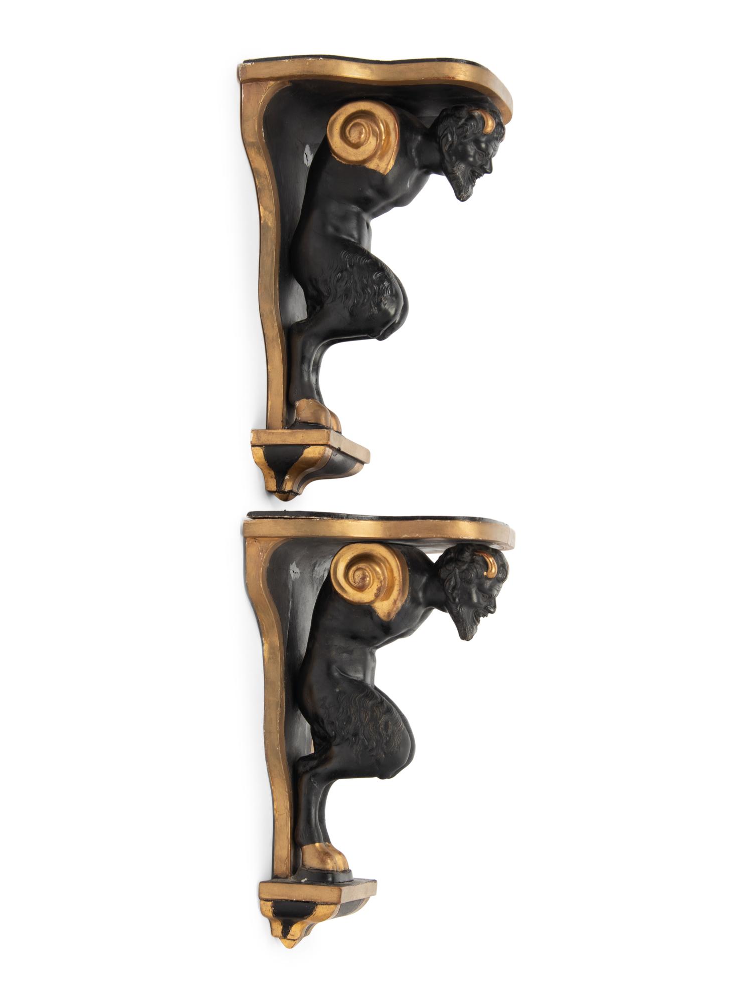 A Pair of Continental Ebonized and Parcel Gilt Wood Figural Brackets