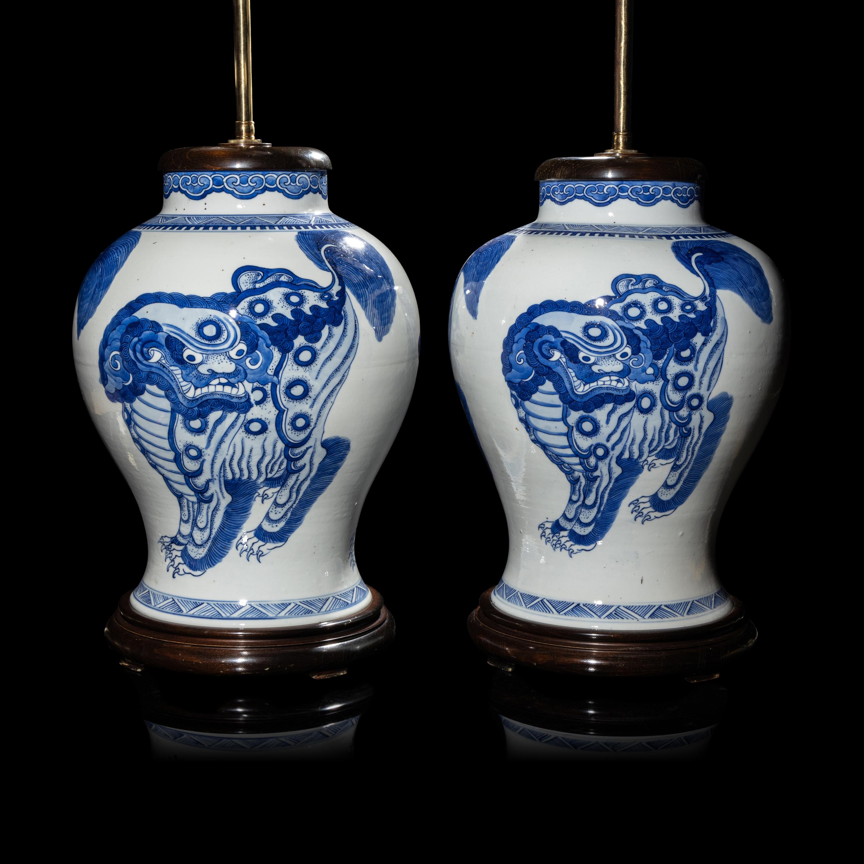 A Pair of Chinese Blue and White 'Buddhist Lion' Porcelain Jars, Kangxi Period or Later 清康熙或更晚 青花佛獅紋罐一對