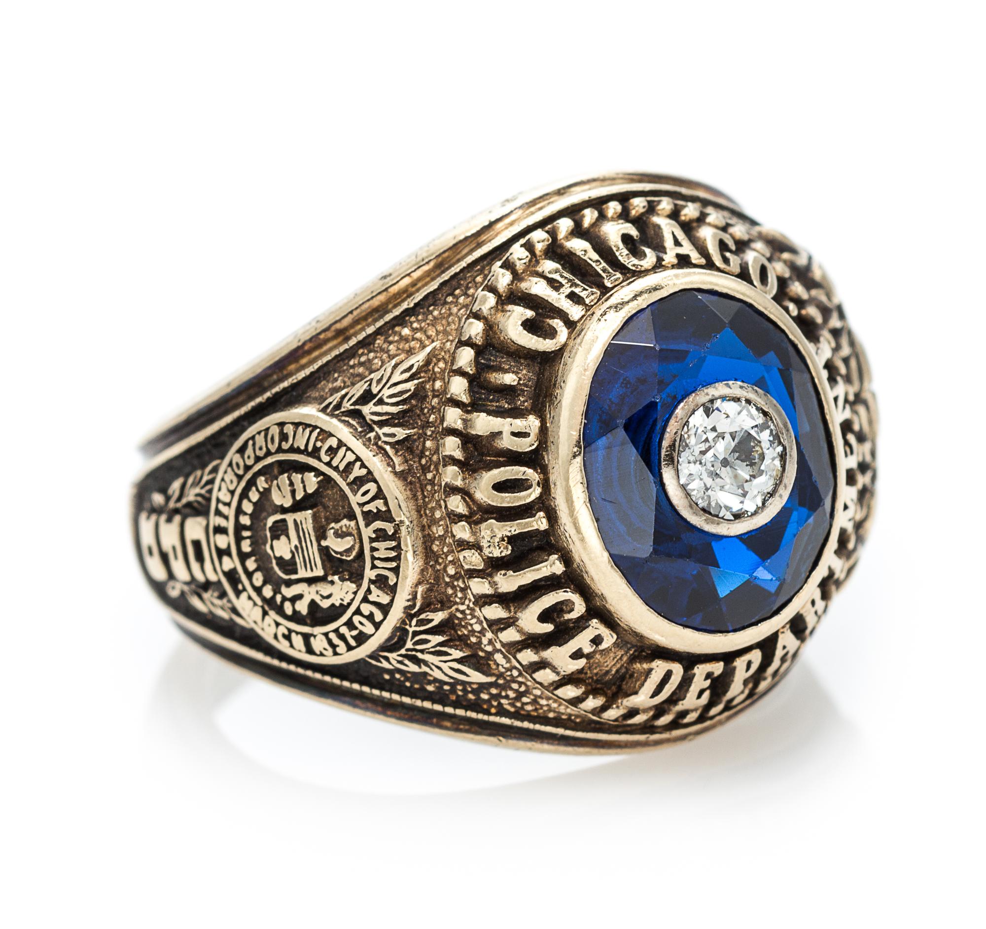 A 10 Karat Yellow Gold, Synthetic Sapphire and Diamond Chicago Police Department Ring, 9.20 dwts.