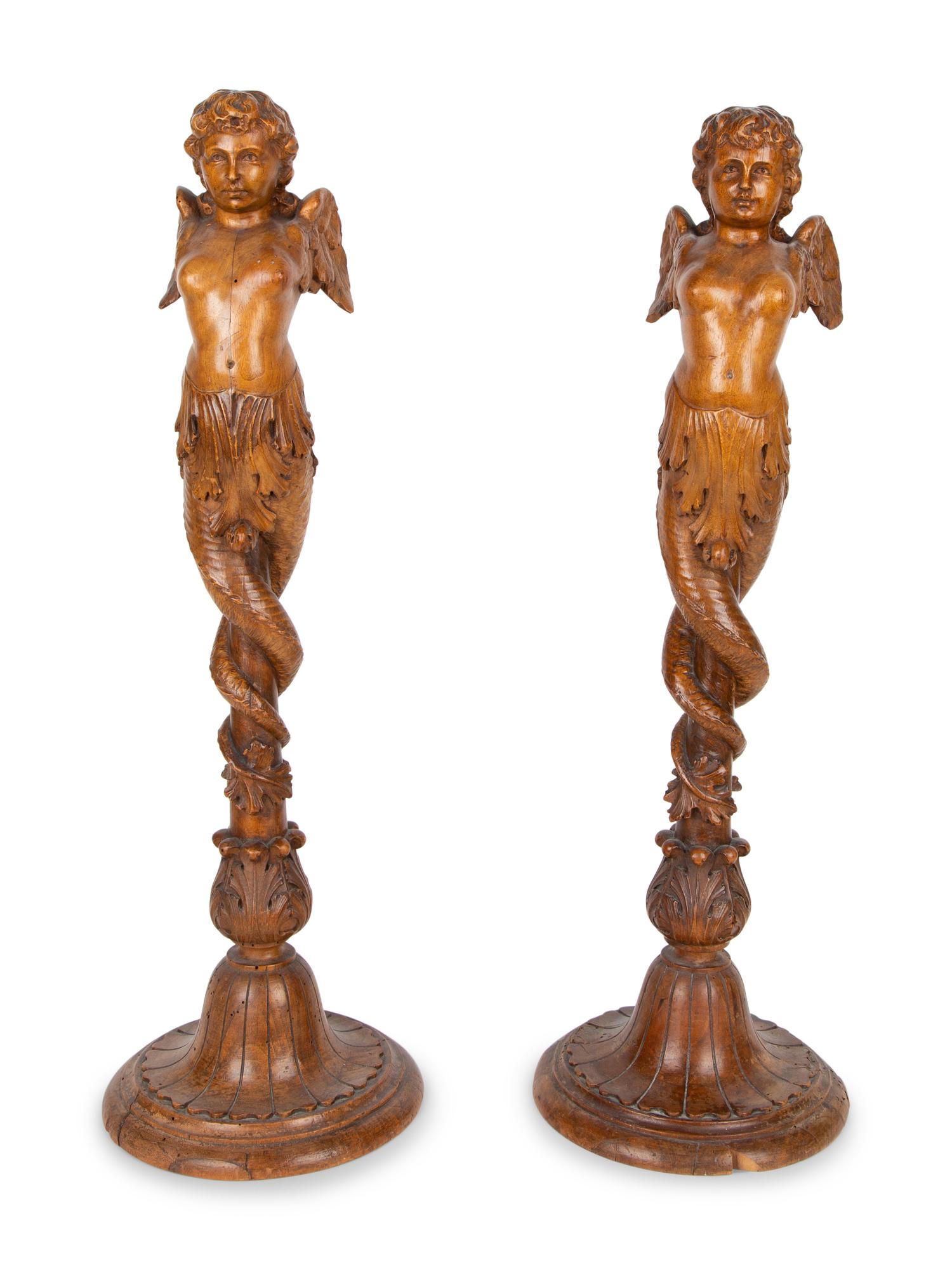 A Pair of Italian Carved Walnut Putti on Fluted Bases — 18TH/19TH CENTURY