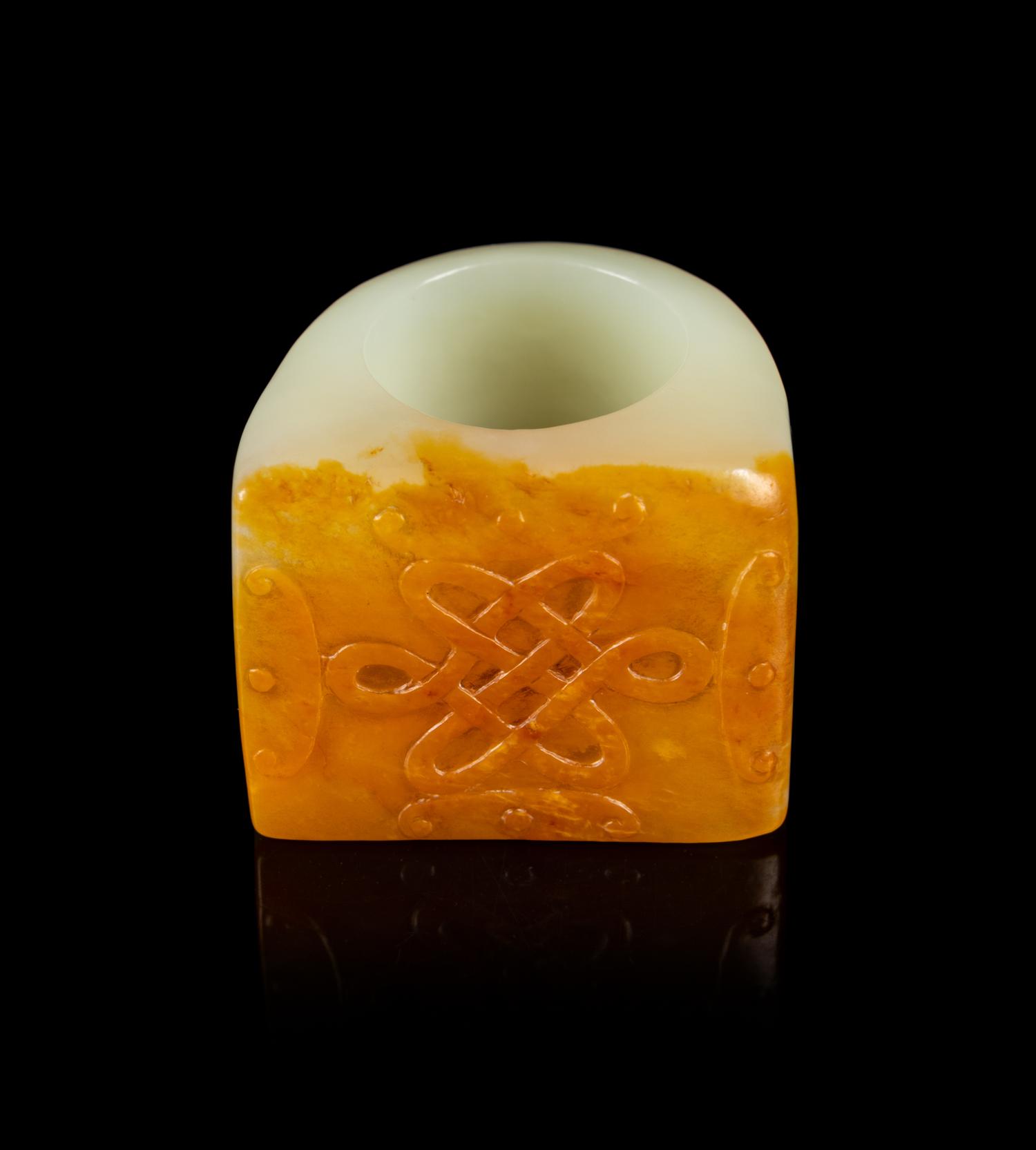 A Chinese Russet and White Jade Archer’s Ring