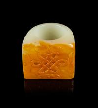 A Chinese Russet and White Jade Archer’s Ring