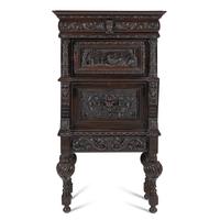 An Italian Renaissance Revival Carved Oak Bureau Cabinet on Stand