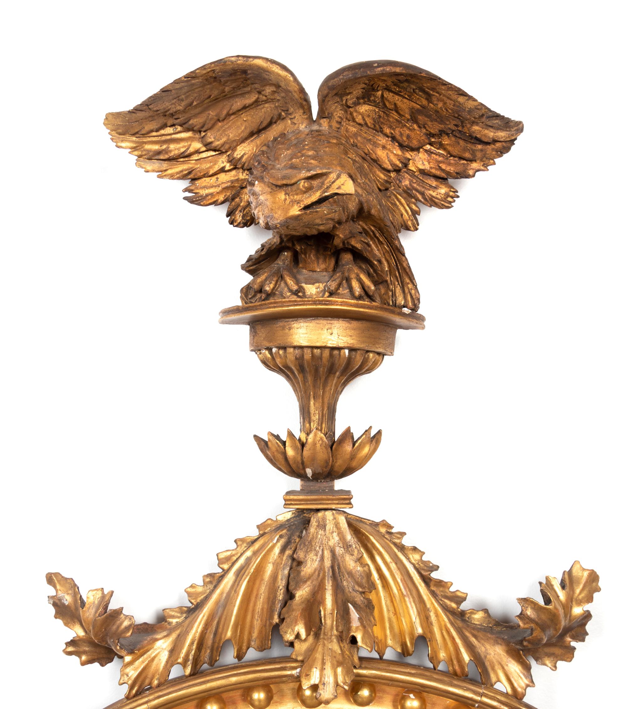 A Regency Carved Giltwood Convex Girandole Mirror by Thomas Fentham