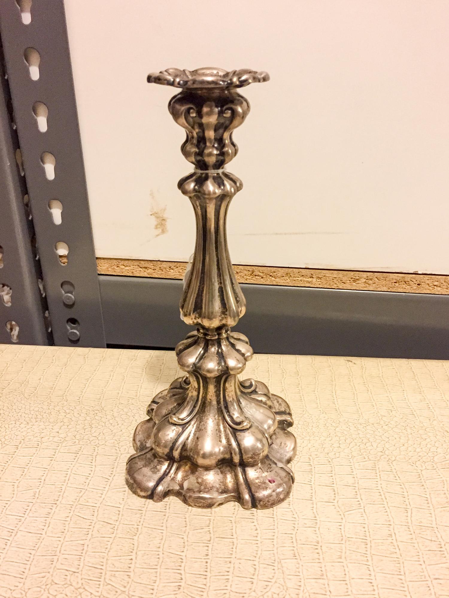 A German Silver Candlestick, , having a lobed, tapering stem and raised on a stepped foot.