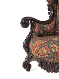A Karpen Carved Mahogany Wingback Armchair