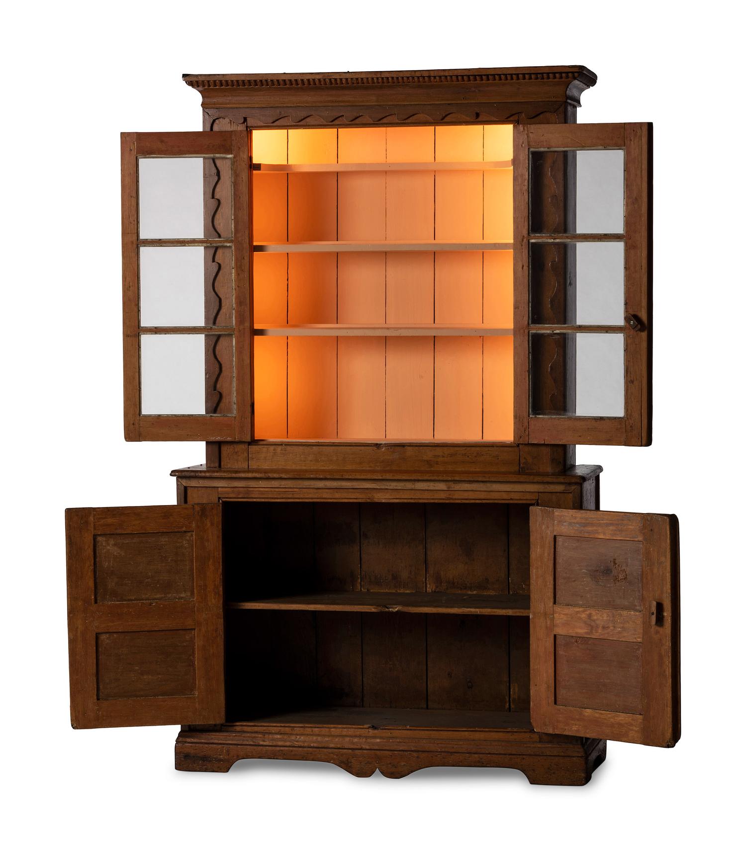 A Folk Art Carved and Paneled Pine Step-Back Cupboard