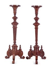 A Pair of Continental Carved Walnut Torchères