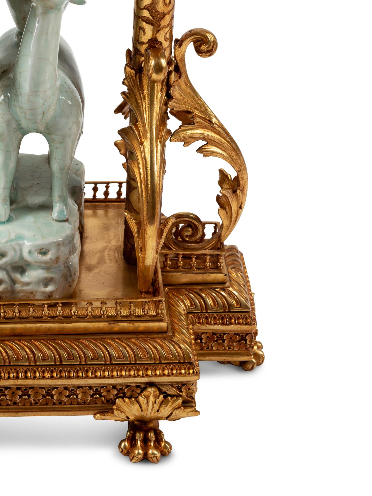 A Continental Gilt Bronze and Celadon Porcelain Figural Chinoiserie Clock