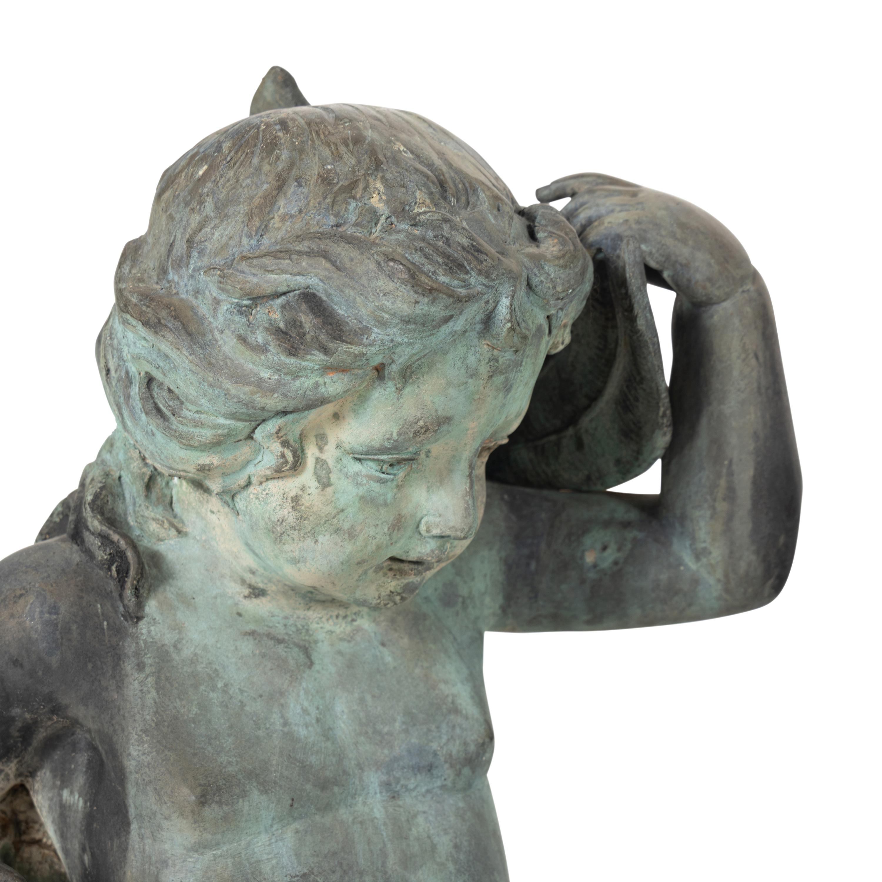 A Patinated Bronze Fountain Figure of a Youth Atop a Dolphin
