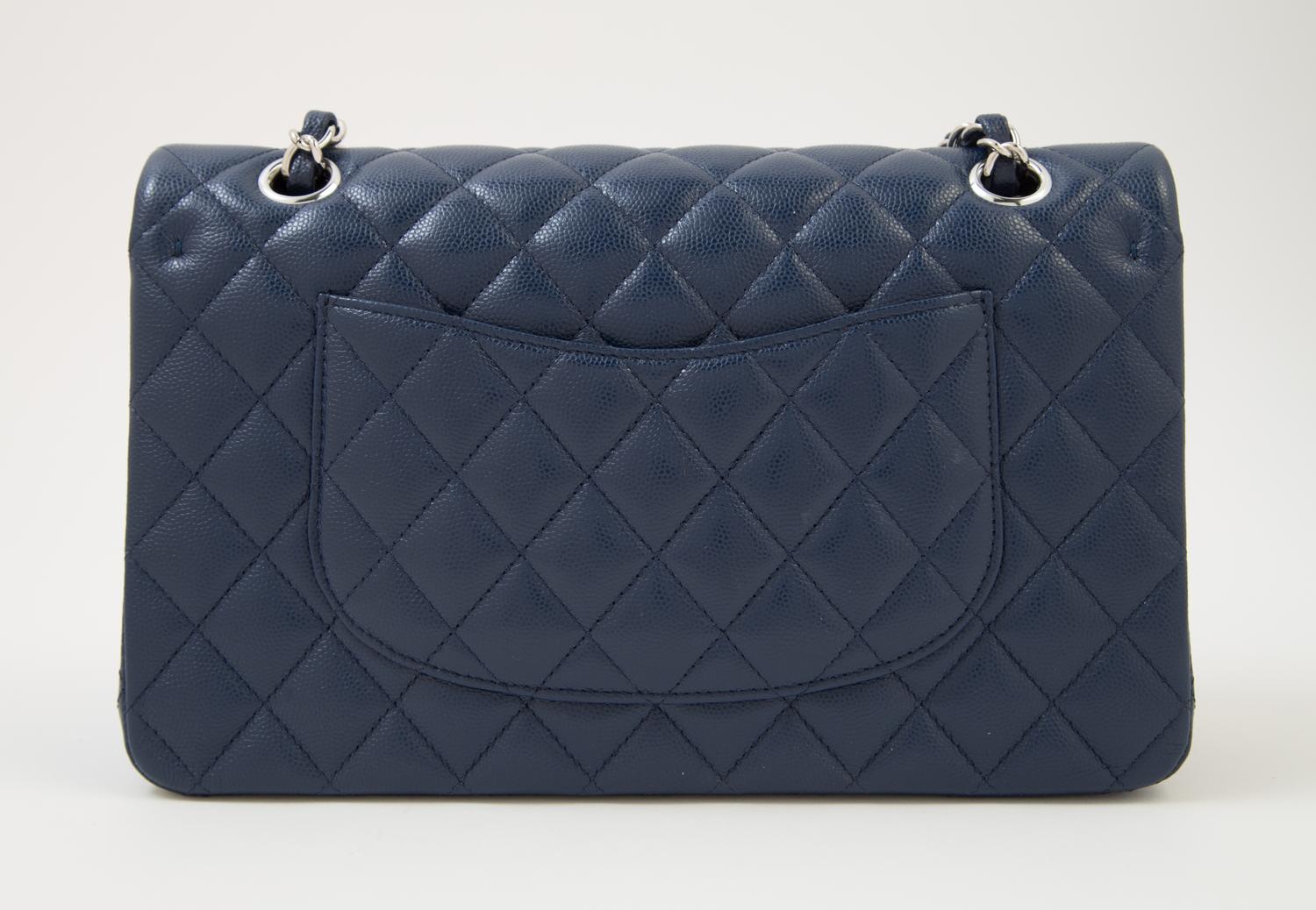 A Chanel Navy Caviar Classic Double Flap Handbag, 10" x 6" x 2.5"; Strap Drop: 9.5".