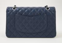 A Chanel Navy Caviar Classic Double Flap Handbag, 10" x 6" x 2.5"; Strap Drop: 9.5".