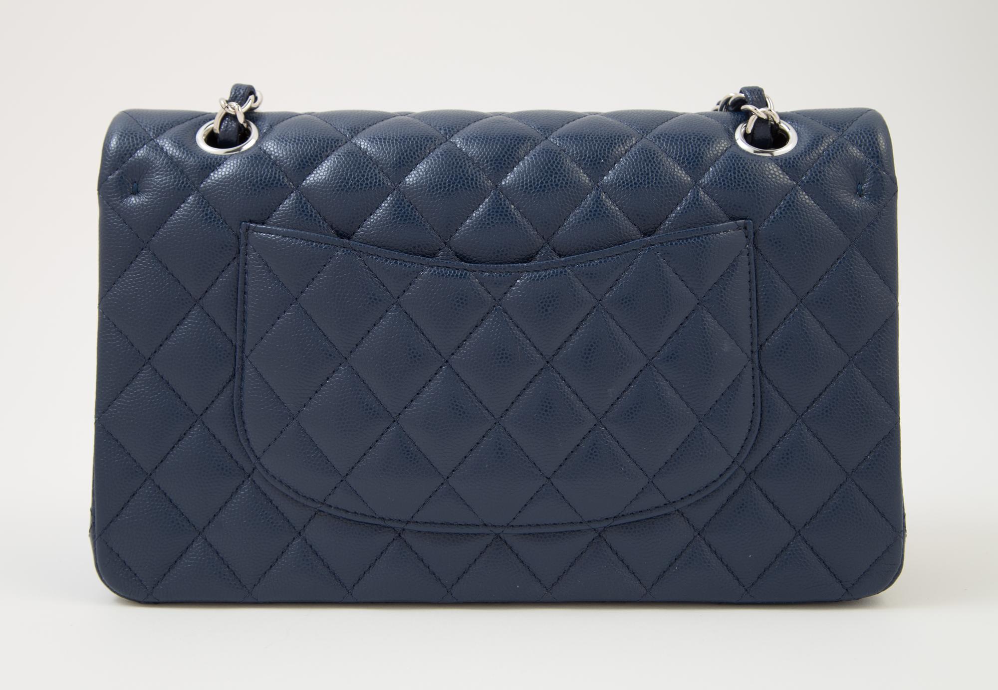 A Chanel Navy Caviar Classic Double Flap Handbag, 10" x 6" x 2.5"; Strap Drop: 9.5".