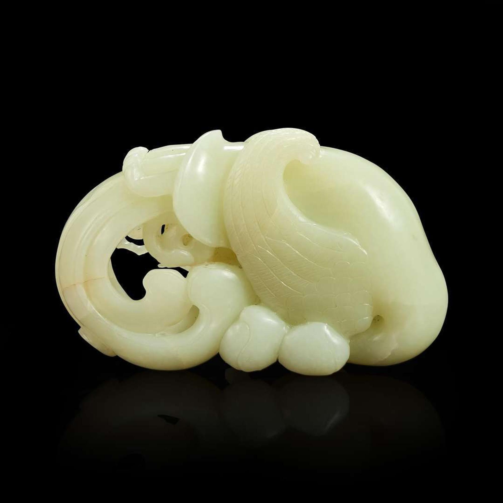 A Chinese carved white jade "Phoenix and Peach" large ornament