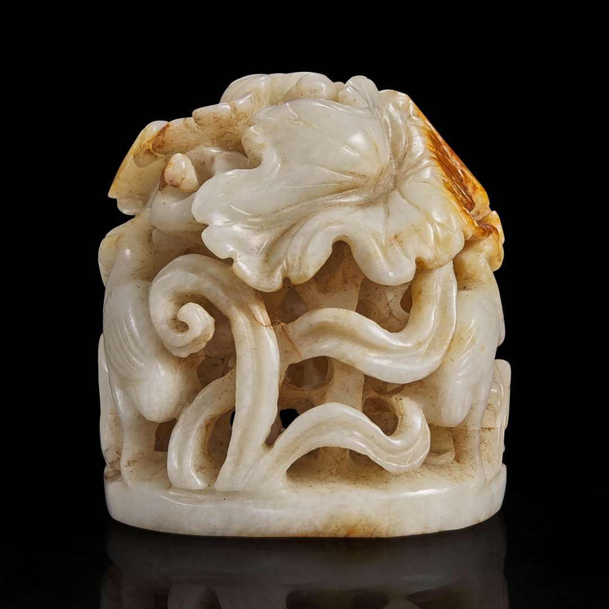 A Chinese reticulated white and russet jade finial 透雕玉炉端