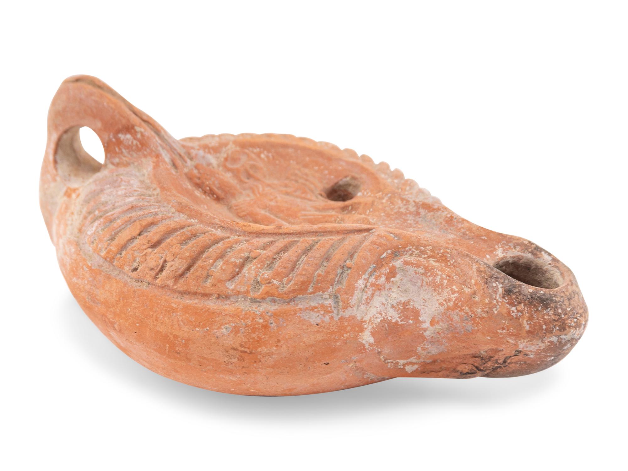 A Roman Terracotta Discus Lamp Depicting the God Hermes
