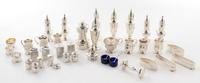 A Collection of American and English Silver Table Articles, of various makers, comprising 16 castors, 4 open salts, a rattle, 4 napkin