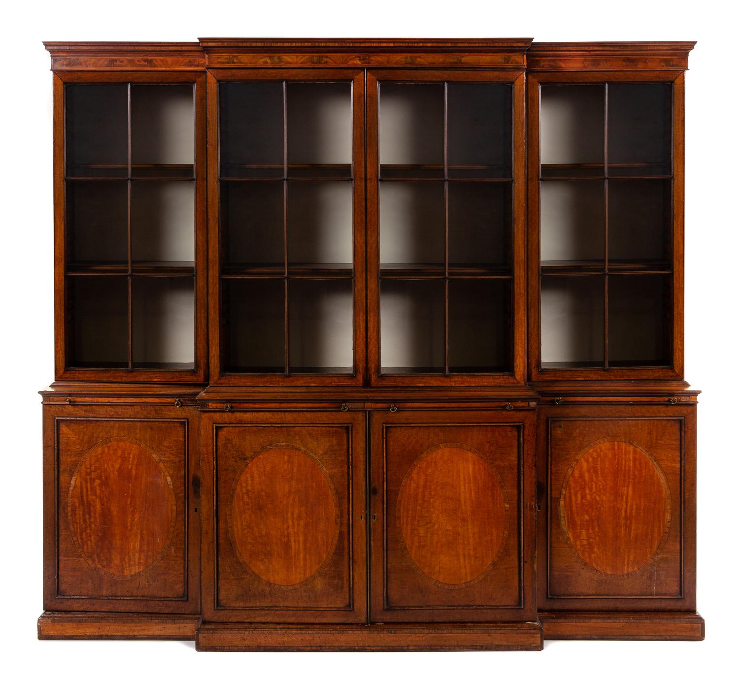 An English Mahogany Breakfront Bookcase Height 94 x width 103 x depth 23 1/3 inches. — 19TH CENTURY