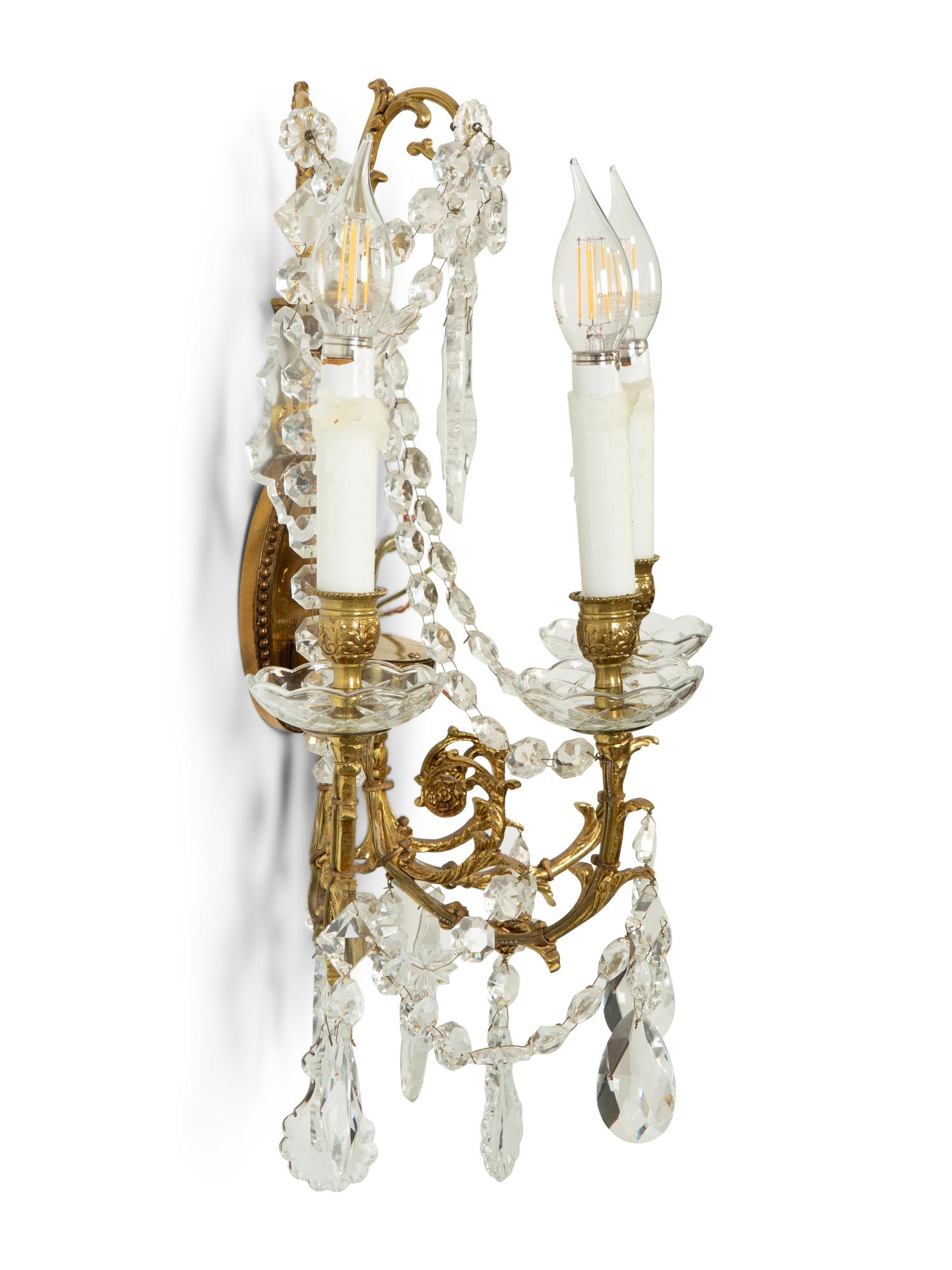 A Pair of Gilt Metal and Cut Glass Three-Light Wall Lights