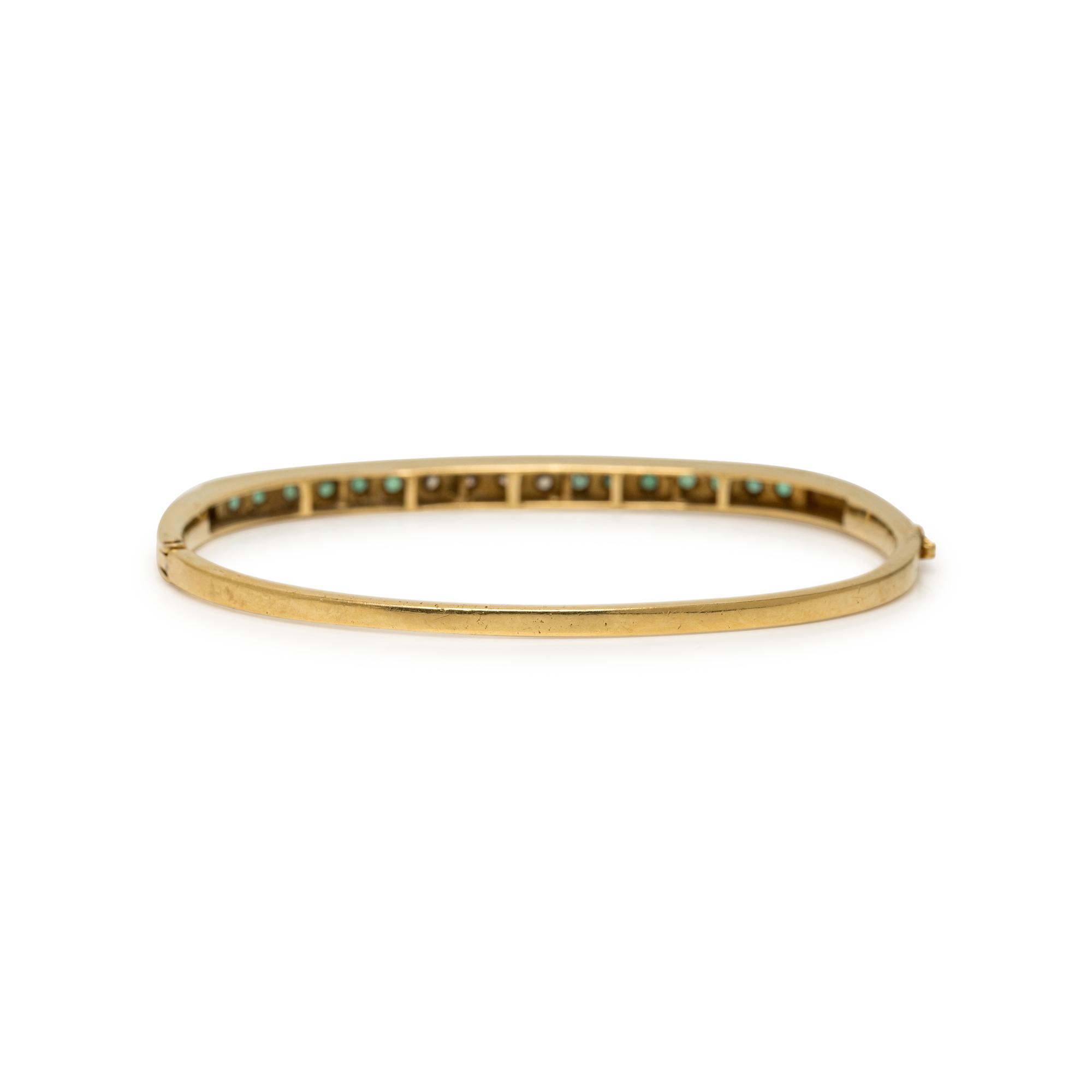 YELLOW GOLD, DIAMOND, AND EMERALD BANGLE BRACELET