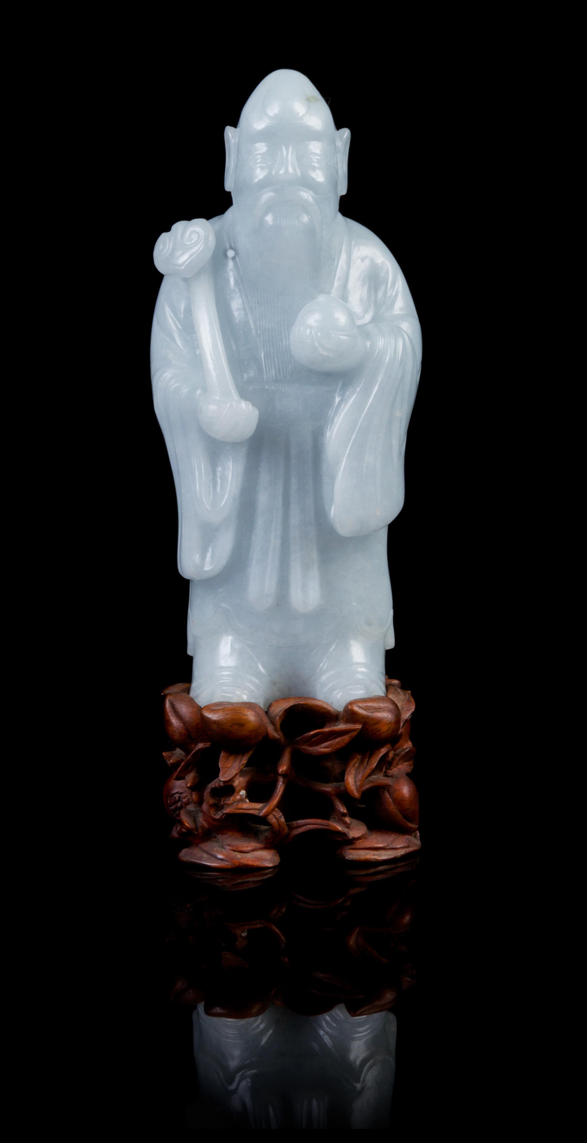 A Chinese Jadeite Figure of Immortal Shoulao LATE 19TH/EARLY 20TH CENTURY Height of jadeite 6 inches. — LATE 19TH/EARLY 20TH CENTURY