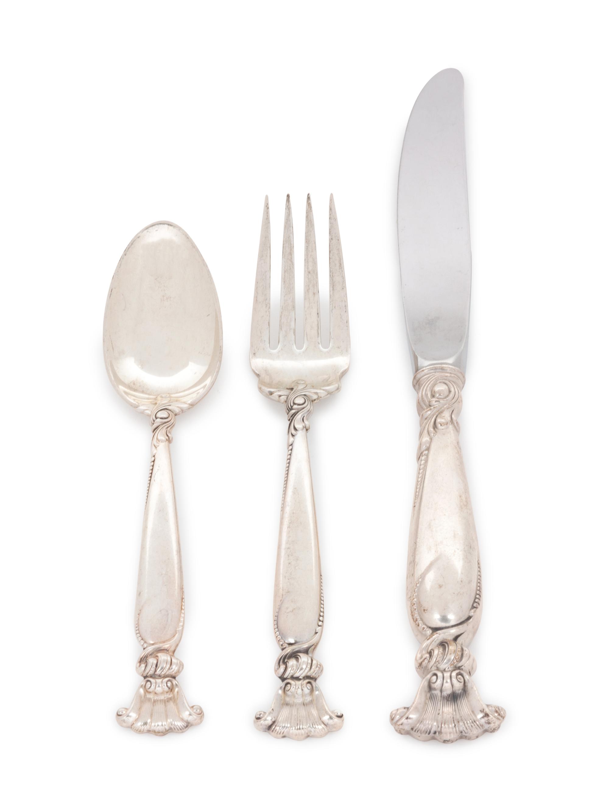 Romance of the Sea pattern, comprising: 1 dinner knife with stainless steel blade 12 luncheon knives with stainless steel blades 12 butter spreaders with stainless steel blades 1 dinner fork 12 luncheon forks 3 salad forks 6 cocktail forks 2 cold meat forks 1 lemon fork 13 teaspoons 12 iced tea spoons 1 serving spoon 1 slotted serving spoon 3 ladles 1 jelly server 81 pieces total.