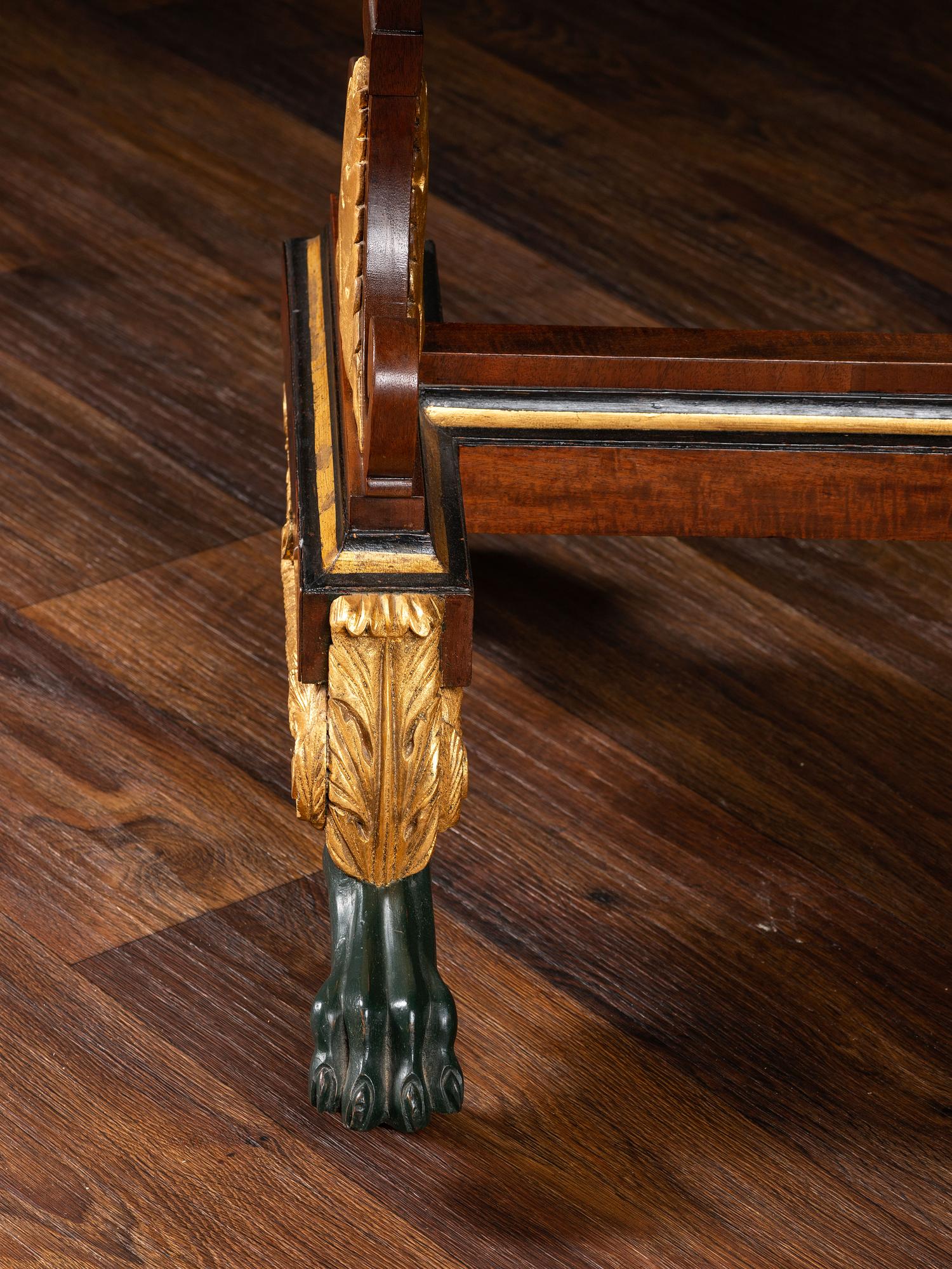 A Classical Parcel Gilt and Ebonized, Figured Mahogany Paw-Foot Drop-Leaf Table