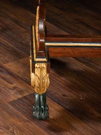 A Classical Parcel Gilt and Ebonized, Figured Mahogany Paw-Foot Drop-Leaf Table