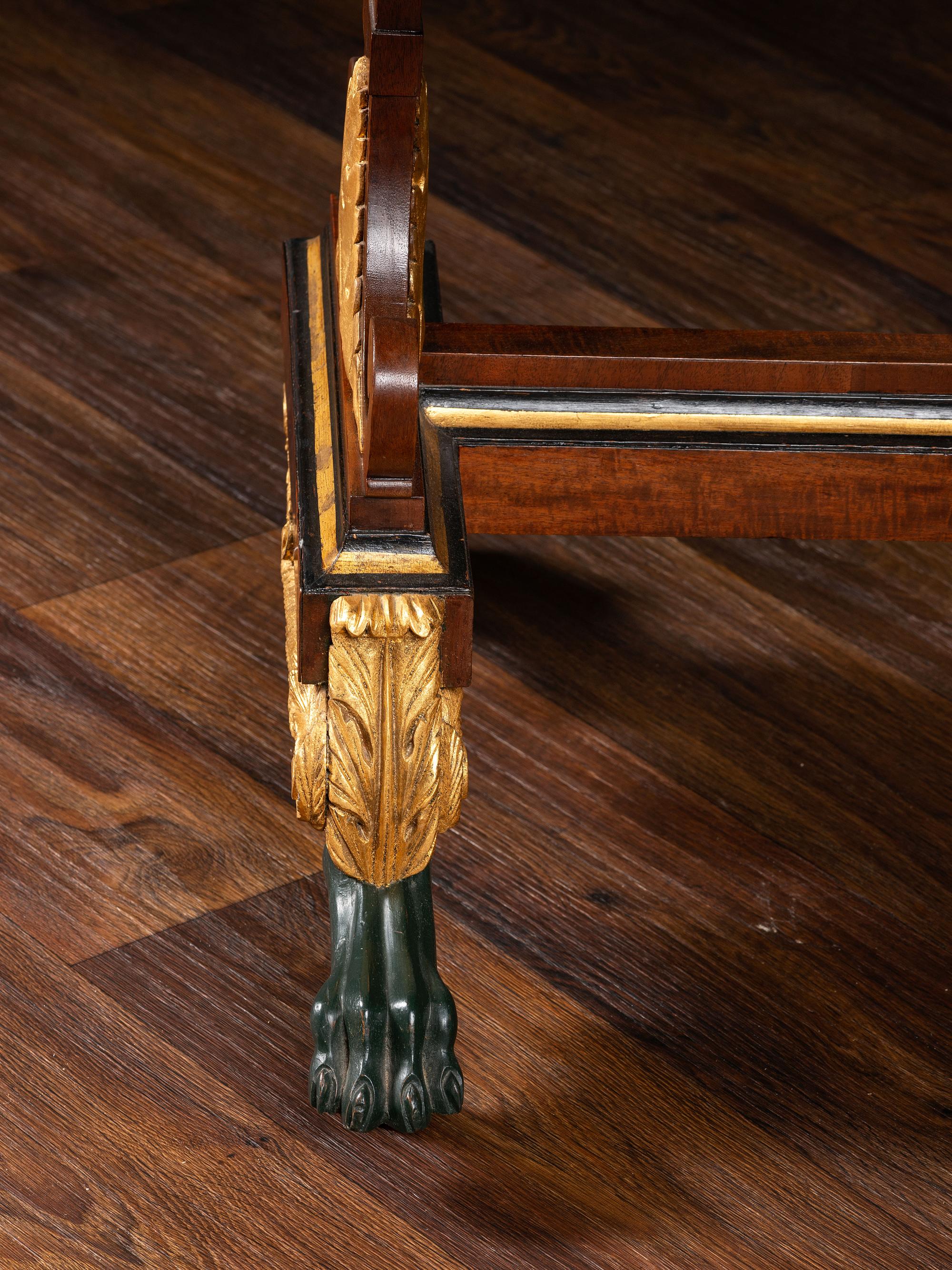 A Classical Parcel Gilt and Ebonized, Figured Mahogany Paw-Foot Drop-Leaf Table
