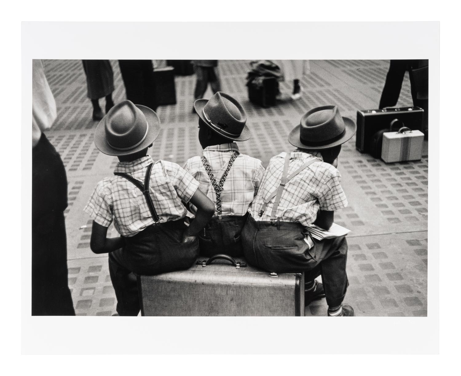 Ruth Orkin (1921-1985) Three Boys on a Suitcase, Penn Station, New York City, 1947