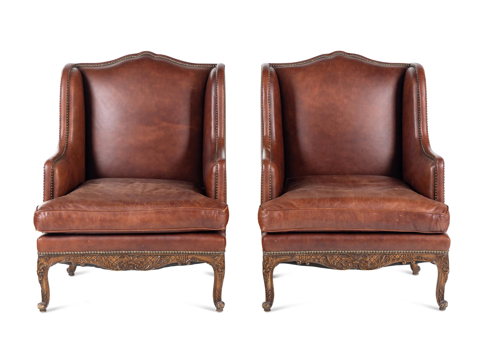 A Pair of Régence Style Leather-Upholstered Wingback Armchairs
