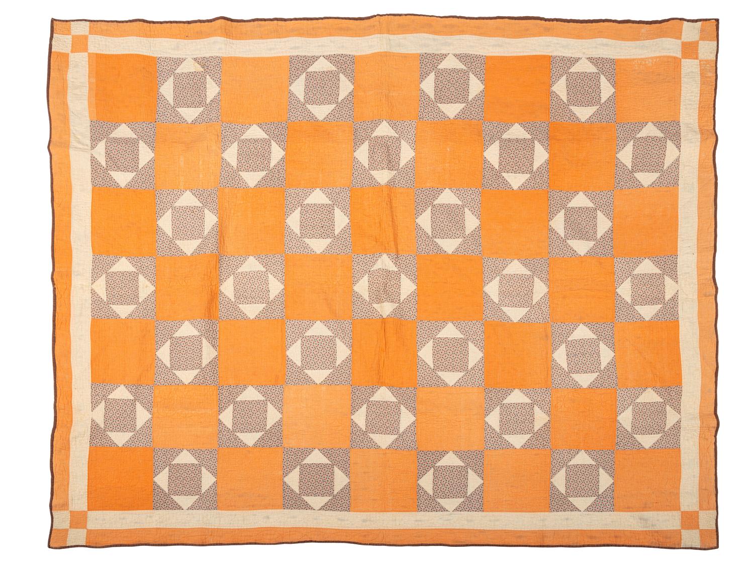 An Orange and Floral Fabric Box Pieced Cotton Quilt