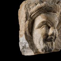 A Roman Marble Relief Fragment with the Head of a Satyr
