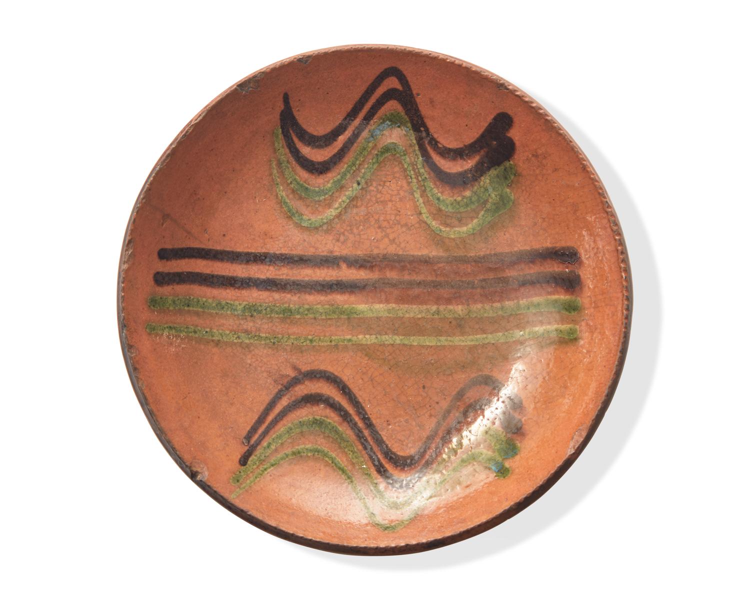 A Green and Brown Slip-Decorated Redware Pie Plate, Dryville, Pennsylvania, 19th Century