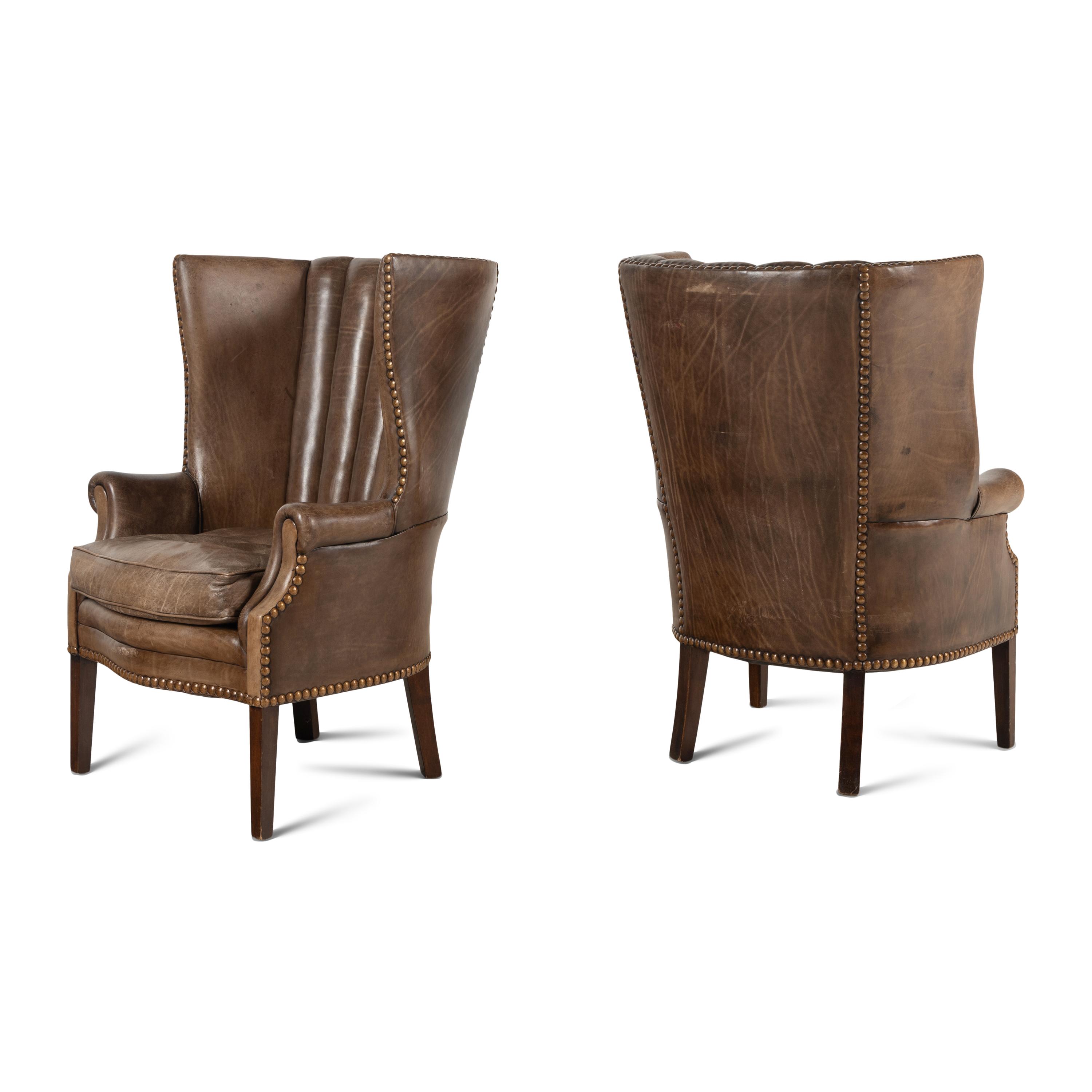 A Pair of Leather Upholstered Wingback Chairs