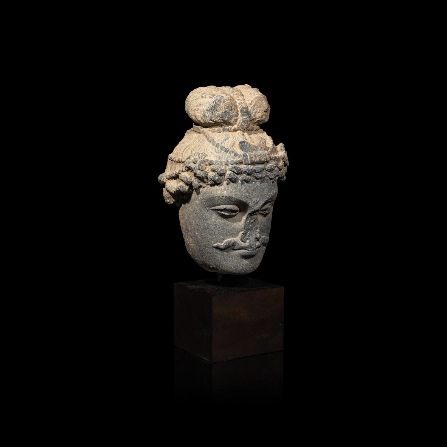 A Gandharan Grey Schist Head of a Bodhisattva, 2nd/3rd Century