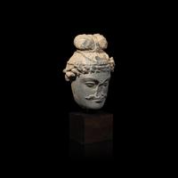 A Gandharan Grey Schist Head of a Bodhisattva, 2nd/3rd Century