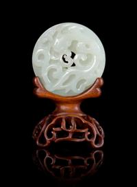 A White Jade 'Dragon' Bi Disc Diameter 2 1/4 inches. — 18TH/19TH CENTURY