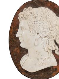 A Set of Four Italian Carved Marble and Iron Mounted Profile Medallions