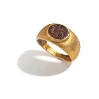 A Roman Gold and Carnelian Finger Ring with Eros Hunting
