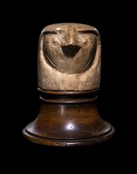 An Egyptian Limestone Canopic Jar Lid in the Form of Qebhsenuef